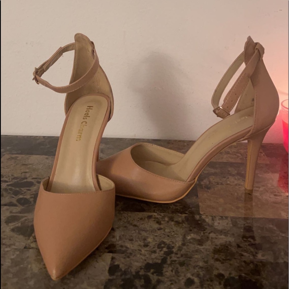 Pointed nude pumps with ankle straps.